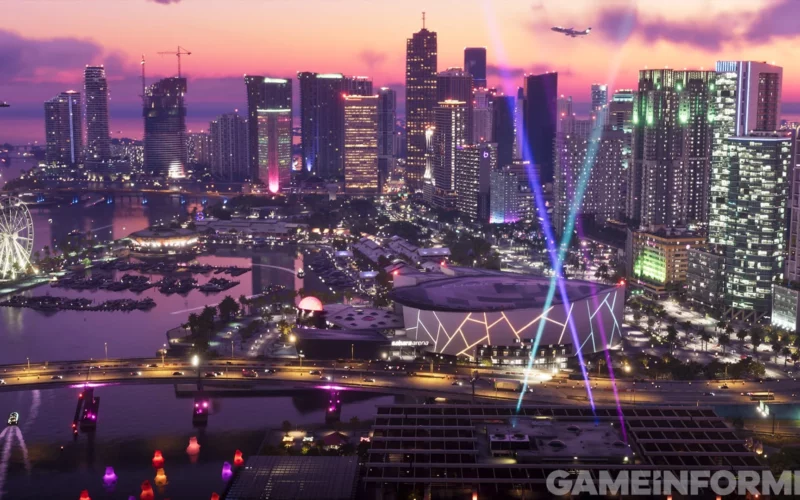 Capture de GTA VI publiée par Game Informer : la skyline de Vice City au crépuscule, avec ses tours illuminées, une grande roue et des faisceaux lumineux au-dessus d’une arène