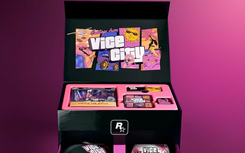 Coffret collector GTA VI The Goodtime State Vice City Collection ouvert, avec l'illustration Greetings from Vice City et la boîte de la figurine Macca the Gator