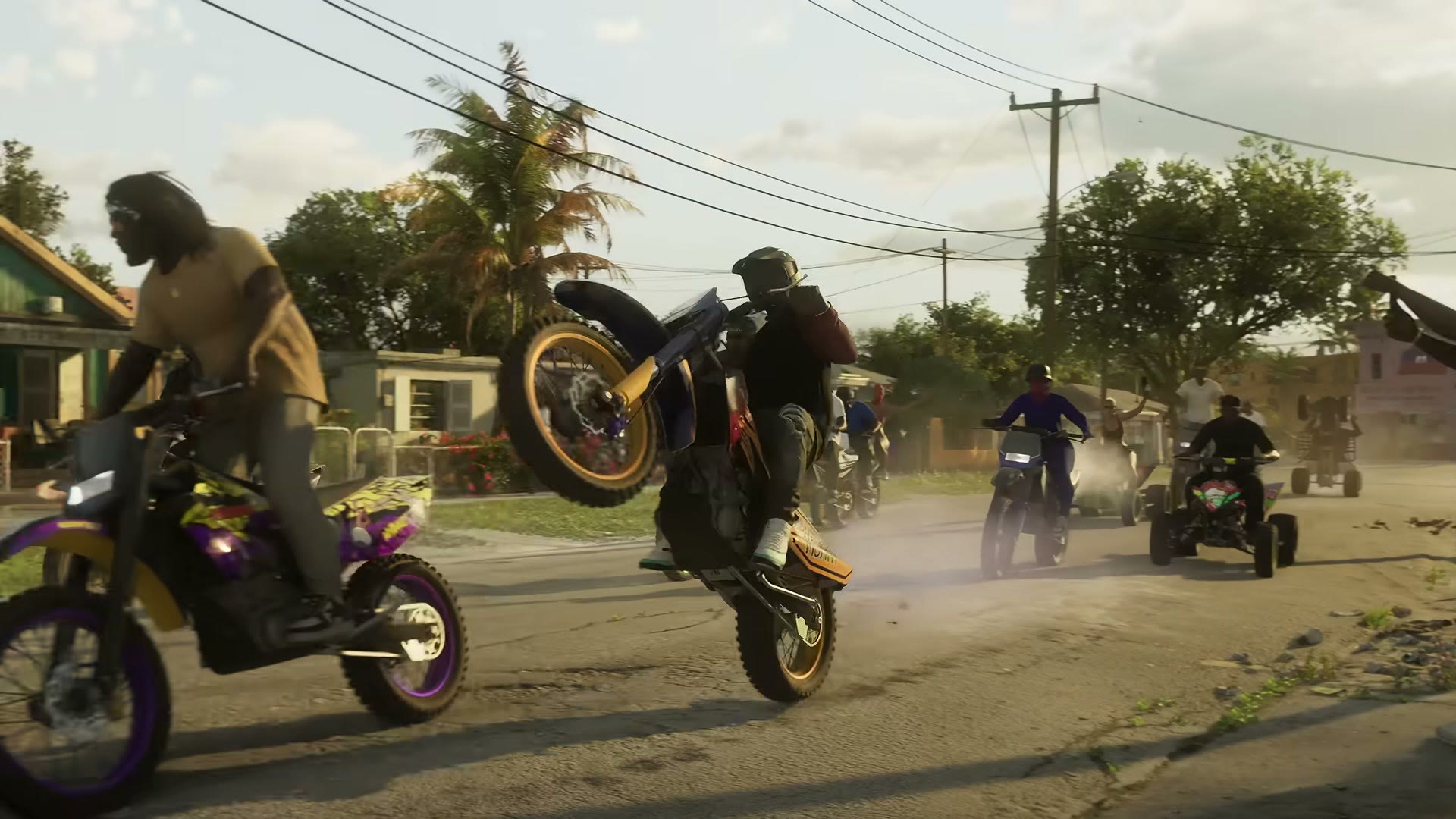 Des motos cross et des quads font des roues arrière dans une rue de quartier de Leonida, dans le Trailer 1 de GTA VI